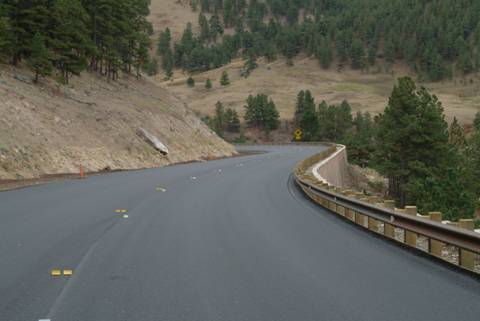 Figure 83.  The steep cut on the north side of the highway and deep canyon on the south illustrate the difficult terrain faced by designers.
