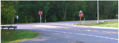 A channelizing separator island at a stop-controlled intersection approach.