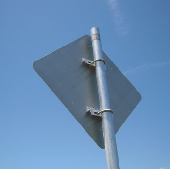 Photo. The rear of a sign backed with aluminum is shown.