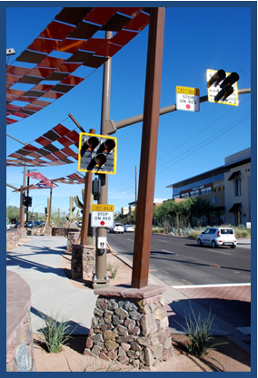 Photo of a post-mounted high-intensity crosswalk beacon designed for a mid-block pedestrian crosswalk in an urban area.