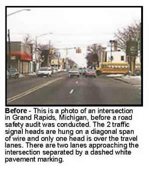 Before - This is a photo of an intersection in Grand Rapids, Michigan, before a road safety audit was conducted. The 2 traffic signal heads are hung on a diagonal span of wire and only one head is over the travel lanes. There are two lanes approaching the intersection separated by a dashed white pavement marking.