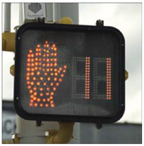 A walk / don't walk traffic signal with a countdown