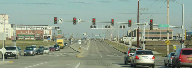 Image shows an intersectinon with signal heads centered over each travel lane