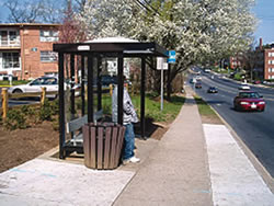 Enhancements to this bus stop include a shelter, bench, level landing pad, and an improved roadway crossing to increase pedestrian safety near the stop.