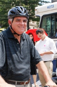 USDOT Secretary Ray Lahood standing with his bicyle.