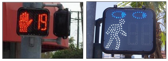 Two photos of pedestrian countdown signals, one that shows the upraised hand for the 'Don't Walk' phase, and the other shows a walking pedestrian during a 'Walk' phase; above the pedestrian is a pair of eyes, indicating pedestrians should look before crossing.