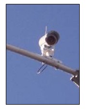 Photo of a camera mounted on a mast arm.