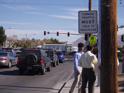 Intersection with Turning Vehicles Yield to Pedestrians sign