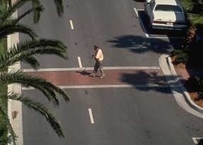 Photo of an pedestrian crossing the street