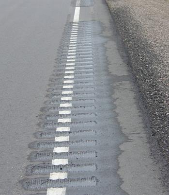 Figure 11. Photograph of rumble stripe during installation on Iowa road. The edge line will be repainted after the rumble is cut.