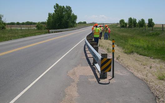 Figure 22. Photograph of Scan Team members at guardrail terminal and pavement on Colorado road.