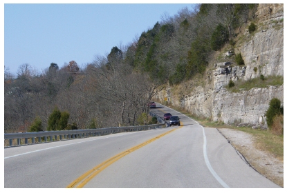 Photo of a roadway hugging a cliff.