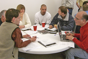 Photo of a Road Safety Audit team sitting around a table in a discussion.