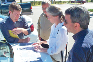 Photo showing a Road Safety Audit team inspecting a drawing. 