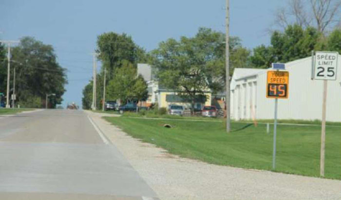 Figure 5-11 Speed feedback sign in Rowley, IA (Image Source: Hallmark et al. 2013). This photo shows a Speed feedback sign reading Your Speed 45 next to a Speed Limit sign of 25.