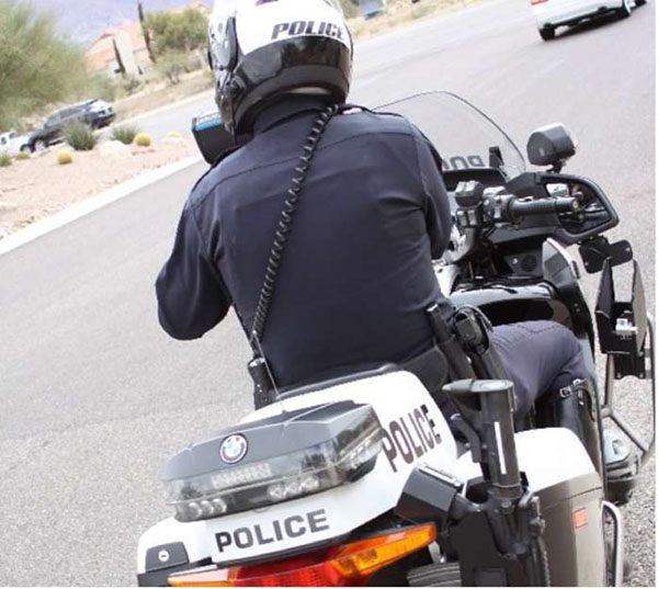 Photo of HiVE enforcement using motorcycles. A police officer is depicted on a motorcycle observing traffic.