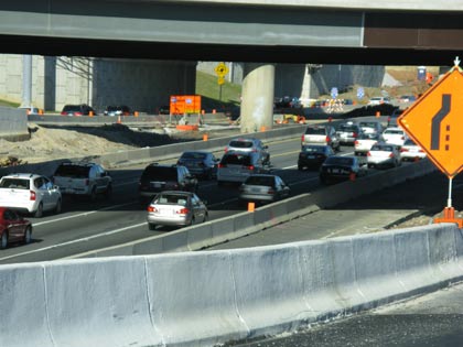 A photo of congestion on a highway that is under construction.