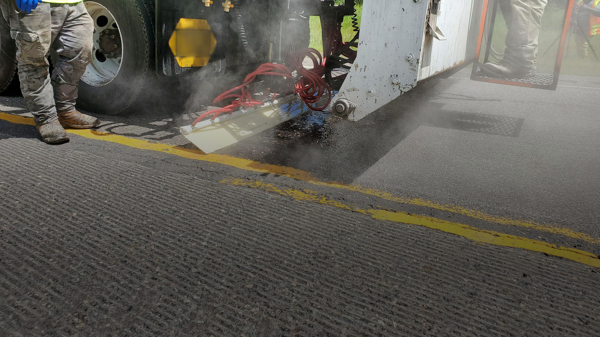 Close up image of the back of truck administering HFST material.