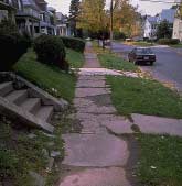 Inadequate maintenance of sidewalks makes a short walk difficult to maneuver.