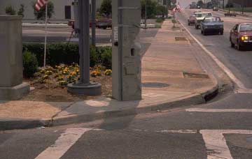 Utilities and the lack of curb cuts makes this intersection very unsafe, limits the mobility of pedestrians, and does not allow for handicapped access.