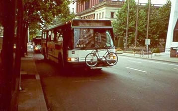 Photo of a bus with a bicycle on the rack in front of the bus
