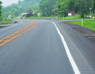 Figure 6. Photo. Milled shoulder rumble strip. This photo shows rumble strips, a series of milled elements, applied on the shoulder next to the edge line, to alert drivers who are leaving the travel lane.