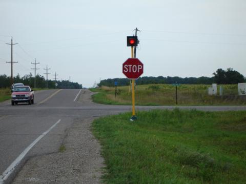 Figure 59.  A STOP sign with a flashing beacon improves visibility of the sign at this intersection with limited vertical sign distance.