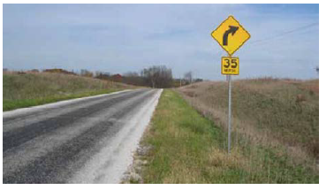 Rural roadway with curve warning sign