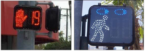 A pedestrian countdown signal showing how many seconds are left in the walk phase and a pedestrian signal in the walk phase enhanced with a pair of eyes to indicate pedestrians should look before crossing traffic even on the walk signal.