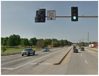 A dedicated left turn lane separated from opposing traffic by a raised median on a rural roadway.