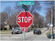 A stop sign with a "4-Way" plaque below mounted below it.