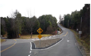 A splitter island separates diverging traffic on a y-shaped roadway.