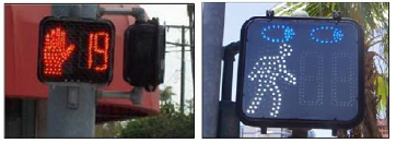 A pedestrian countdown signal showing how many seconds are left in the walk phase next to a pedestrian signal in the walk phase enhanced with a pair of eyes to indicate pedestrians should look before crossing traffic even on the walk signal.