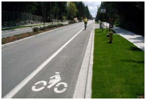 A dedicated bicycle lane separated from through traffic by lane markings.