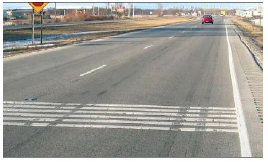 Transverse rumble strips spanning a two-lane single-direction road.