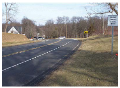 A two-lane roadway with centerline and edgeline markings.