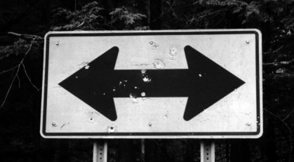 Photo of a damaged sign with holes on the surface