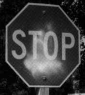 Photo of a STOP sign sprayed with light-colored paint