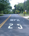 Photo.  A photo showing the regulatory pavement markings ' 25 MPH.'