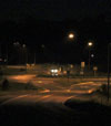 Photo.  A rural roundabout with lighting.