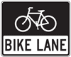 Graphic.  A black and white bike lane sign.  The top of the sign shows a bicycle and the bottom of the sign includes the text 'Bike lane.'