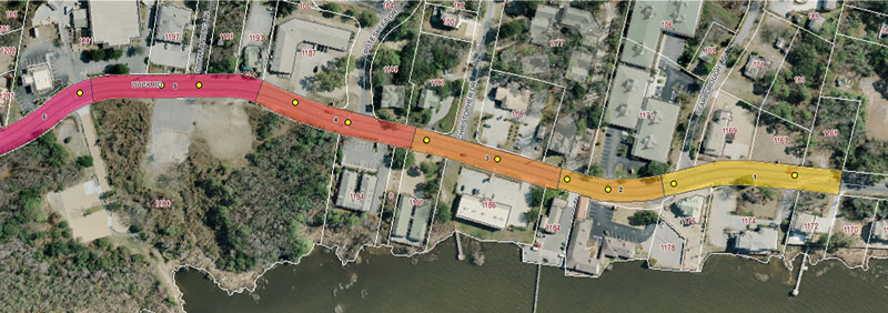 Graphic.  An aerial photograph of the study area.  The roadway is color-coded and split into six section with each section having a different color.  Roadway section four is circled and Table 1 below includes the data for this section.