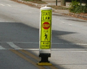 Photo.  A pedestrian knock-down sign.