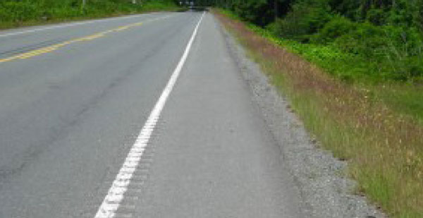 Photo.  A photo of a rumble stripe, which is a narrow rumble strip that is overtop the roadway edgeline pavement marking that separates the travel lane from the shoulder.  