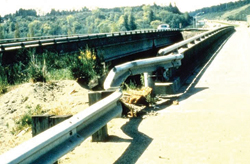 Photo. This photo shows a guardrail which is extermemly bent in advance of a rigid object.