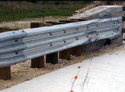 Photo. This photo shows a traditional transition from a guardrail to a bridge parapet.