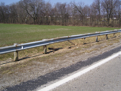 7. Photo. This photo shows a guardrail with two broked posts.