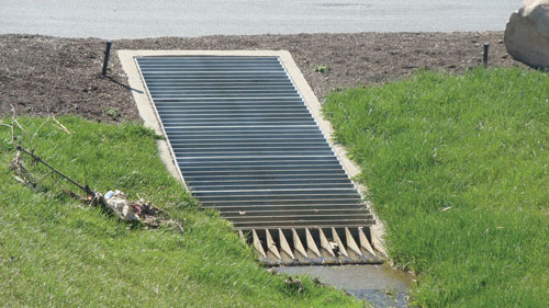Photo. This photo shows a grated inlet covering a culvert end. 