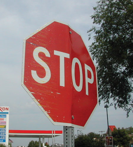 Photo. A bent stop sign is shown.