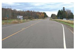 Photo of a widened area to the right of the travel lane on a rural roadway that allows through vehicles space to move around left-turning vehicles.